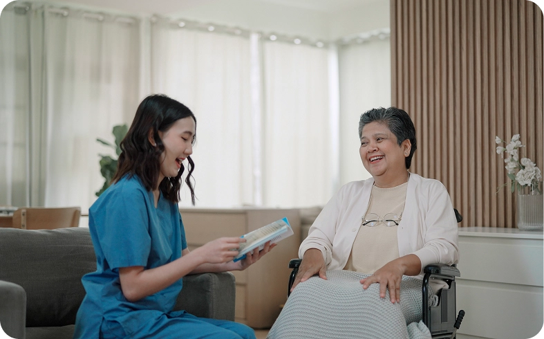 Smiling nurse and elderly woman sharing a moment