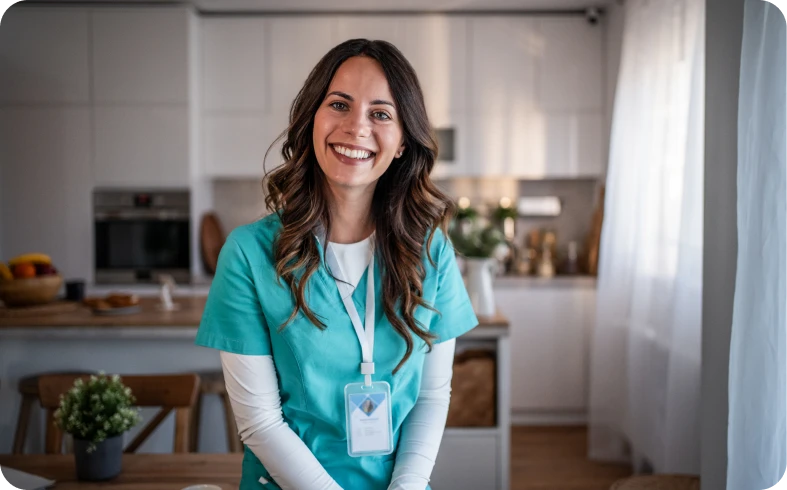 Nurse in teal uniform with badge indoors.