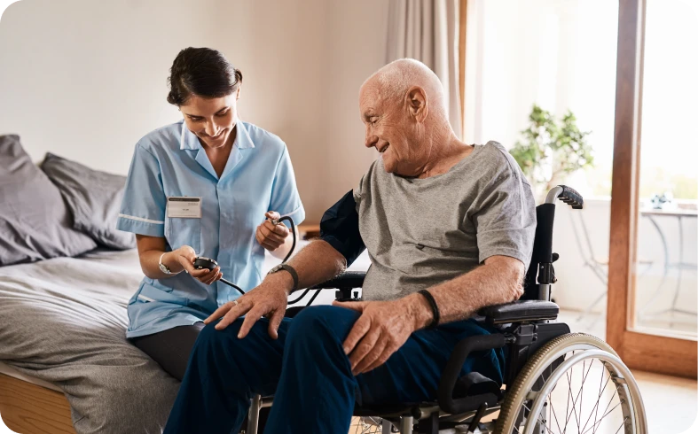 Healthcare worker measuring senior's blood pressure.