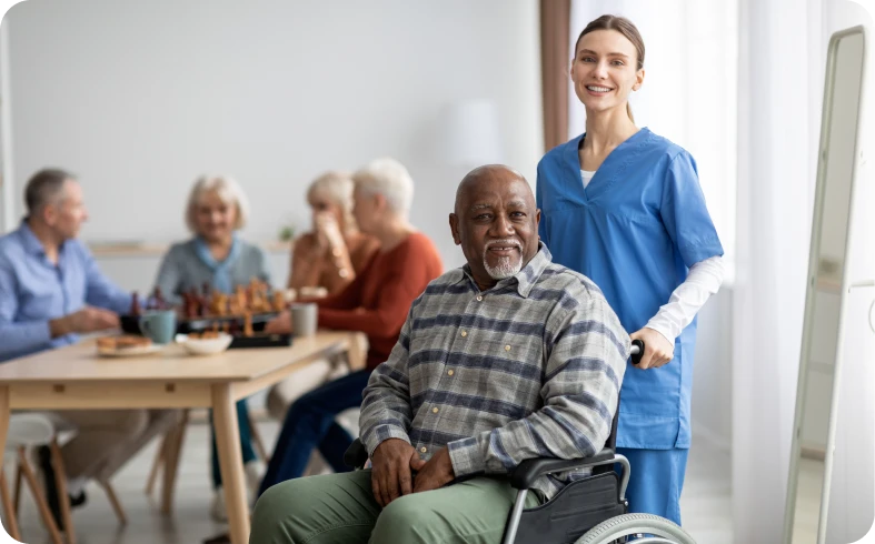 Smiling nurse with senior man indoors