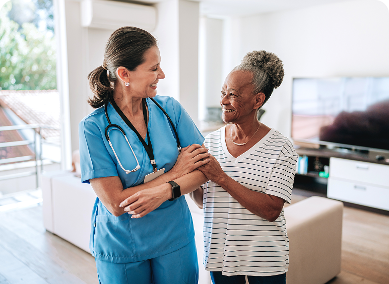 Nurse assisting elderly woman in living room.
